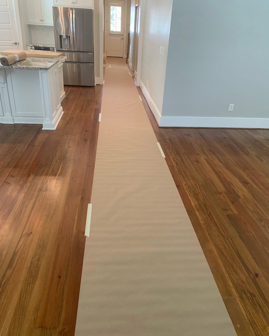 Hardwood floors covered with protective paper before a move-in