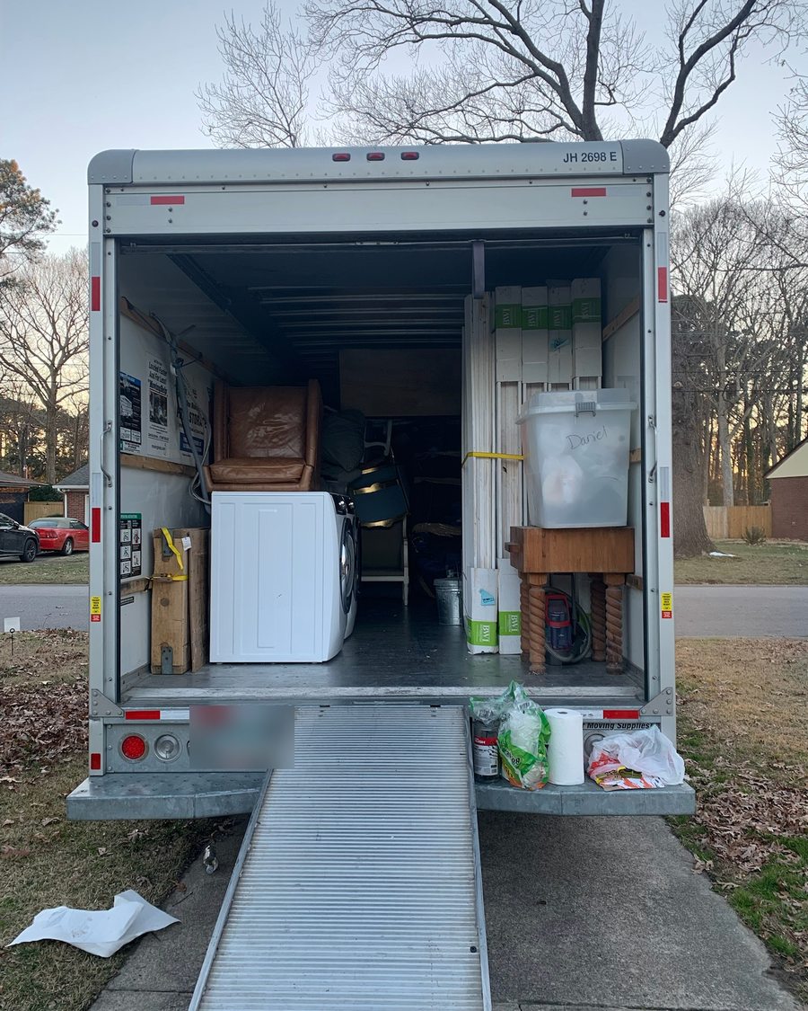 Box truck loaded with wrapped furniture and appliances on a Red Line Works moving day