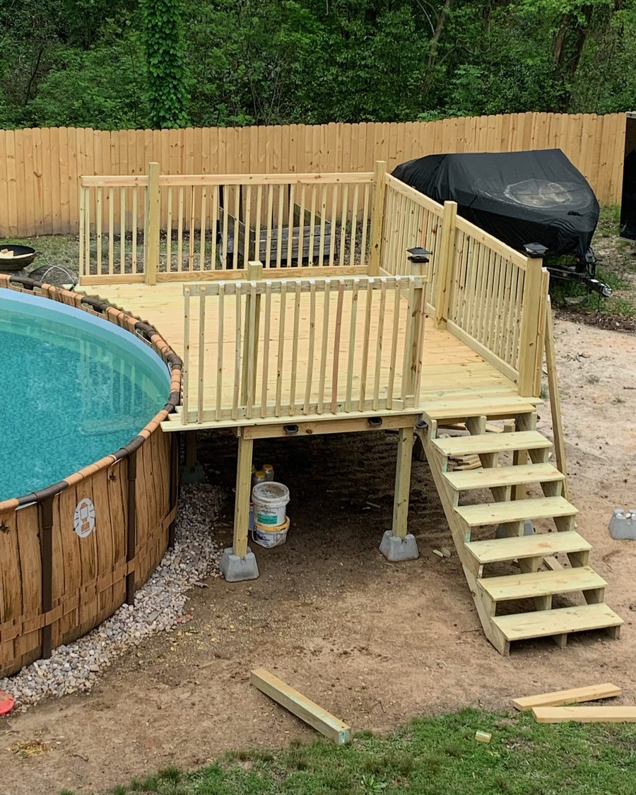 New wood pool deck and stairs built beside an above-ground pool