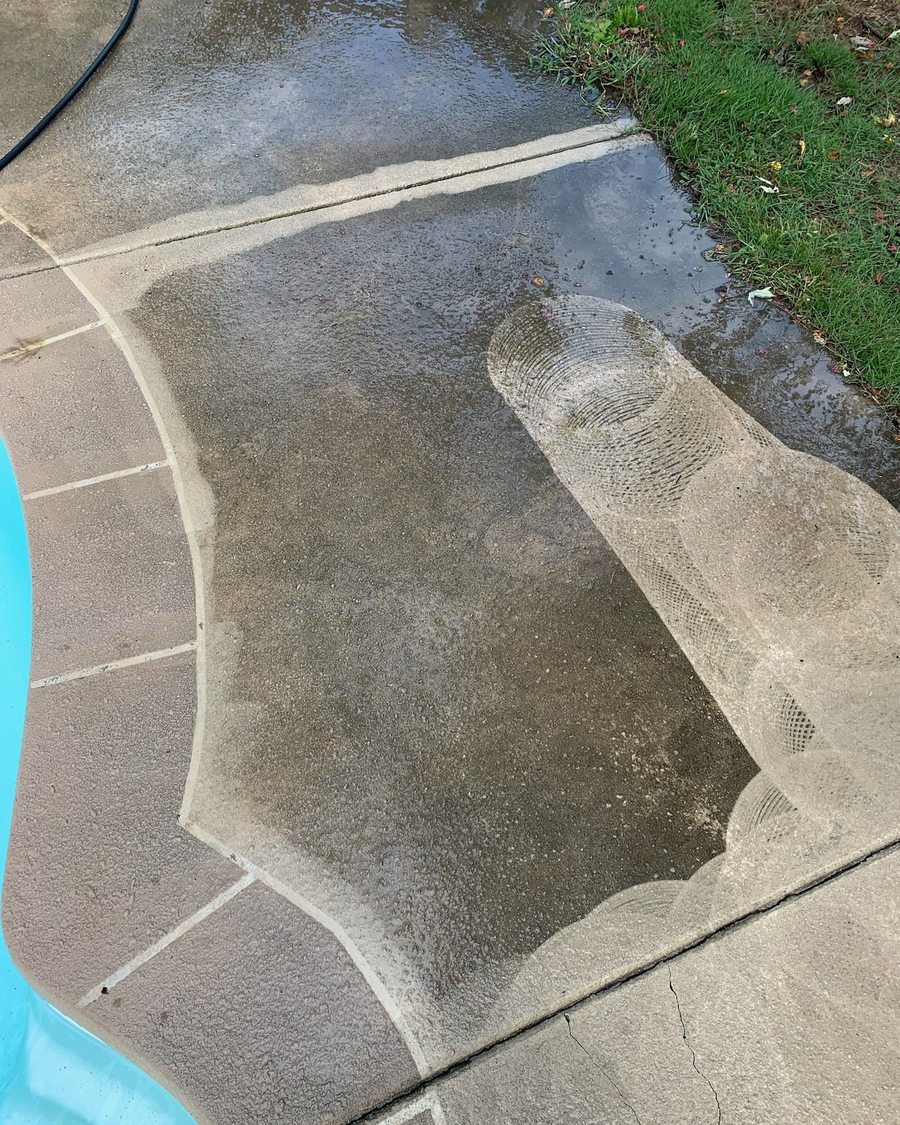 Pool deck concrete mid pressure wash with a clean line showing the difference